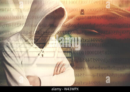 Faceless hooded anonymous computer hacker Stock Photo
