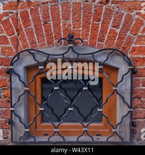 Abstract image texture for designers with figured steel window shutters. Beaten metal and red bricks rhomb. Stock Photo