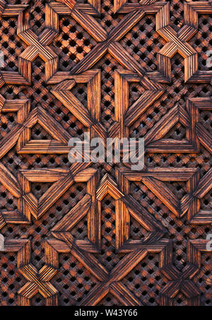 Morocco, Fez. Original Medieval Arabesque style wooden panel with Islamic symmetrical patterns. Stock Photo