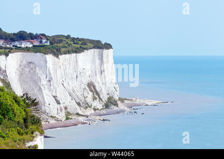 Edge of white cliffs of Dover, English Channel blue waters on a sunny summer day . Stock Photo