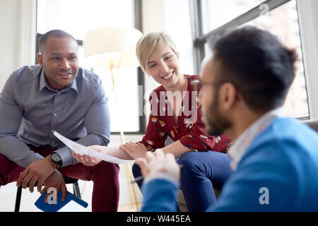 Multi-ethnic team of creative millenials collaborating on a brainstorm project Stock Photo