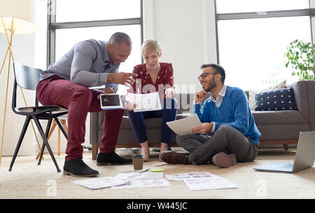 Multi-ethnic team of creative millenials collaborating on a brainstorm project Stock Photo