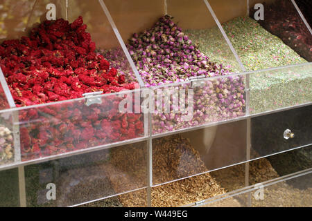 Dried herbs and flowers in transparent boxes on the counter in a street market in Dubai Stock Photo