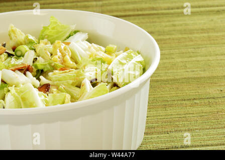 A bowl of coleslaw made from Napa cabbage and sprinkled with toasted almonds