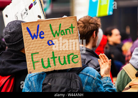 A cardboard sign is viewed close-up saying we want a future as a crowd of environmental campaigners march against climate change in Montreal, Canada Stock Photo