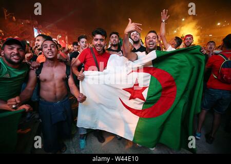 Algiers. 20th July, 2019. Algerian fans celebrate the team's victory in Africa's Cup of Nations in Algiers, Algeria, July 19, 2019. Algeria beat Senegal in Africa's Cup of Nations final by 1-0 and claimed the title of the event in Egypt's Cairo July 19. Credit: Xinhua/Alamy Live News Stock Photo