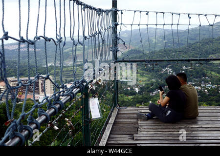 ANTIPOLO CITY, PHILIPPINES – JULY 17, 2019: Visitors and tourists enjoy the view and cool breeze at the top of the 360 degree viewing deck of a restau Stock Photo