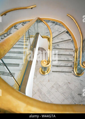 Beautiful Brass and glass spiral staircase with white marble floors inside the Alabama State capitol in Montgomery, AL, USA Stock Photo