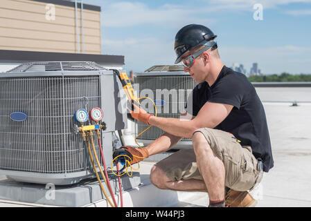 Hvac technician inspecting an condensing unit. Stock Photo