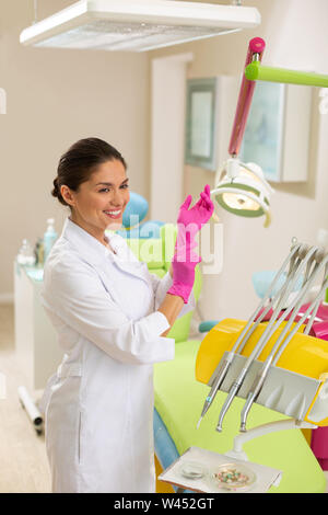 Doctor wearing a lab coat and aseptic gloves Stock Photo