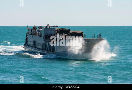 190719-N-DX072-1046 STANAGE BAY, Australia (July 19, 2019) Landing Craft, Utility (LCU) 1666 approaches the well deck of the amphibious transport dock ship USS Green Bay (LPD 20). Green Bay, part of the Wasp Expeditionary Strike Group, with embarked 31st Marine Expeditionary Unit, is currently participating in Talisman Sabre 2019 off the coast of Northern Australia. A bilateral, biennial event, Talisman Sabre is designed to improve U.S. and Australian combat training, readiness and interoperability through realistic, relevant training necessary to maintain regional security, peace and stabilit Stock Photo