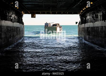 190719-N-DX072-1025 STANAGE BAY, Australia (July 19, 2019) Landing Craft, Utility (LCU) 1666 departs the well deck of the amphibious transport dock ship USS Green Bay (LPD 20). Green Bay, part of the Wasp Expeditionary Strike Group, with embarked 31st Marine Expeditionary Unit, is currently participating in Talisman Sabre 2019 off the coast of Northern Australia. A bilateral, biennial event, Talisman Sabre is designed to improve U.S. and Australian combat training, readiness and interoperability through realistic, relevant training necessary to maintain regional security, peace and stability. Stock Photo