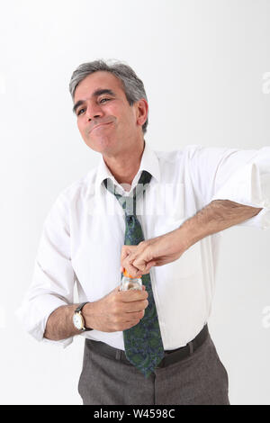 Businessman opening a pill bottle Stock Photo