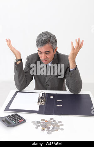 Depressed businessman working out finances Stock Photo