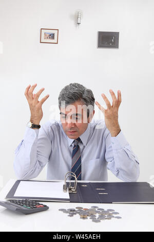 Depressed businessman working out finances Stock Photo