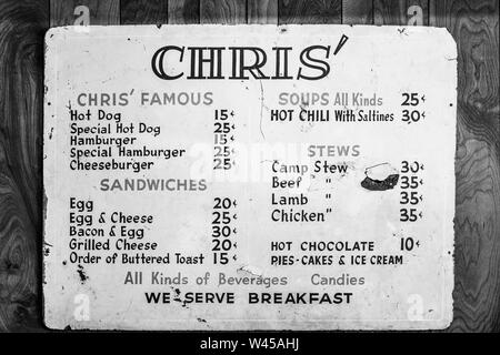 Chris' Menu, A vintage metal menu sign hanging on the wall at Chris' Famous Hot Dogs, Montgomery, AL, USA, in black and white Stock Photo