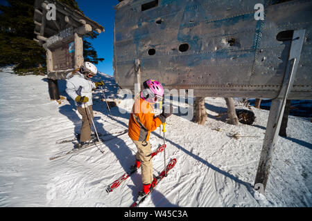 Skiers rub the wing fragment of the B-24 that crashed on Mission Ridge for good luck and to ensure it snows a lot. Many perform this ritual every run. Stock Photo