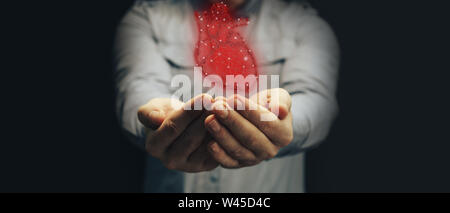 Human hand holding neon red heart innovative technologies. Mixed media. Stock Photo