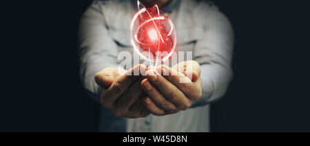 Human hand holding neon red heart and atom innovative technologies. Mixed media. Stock Photo