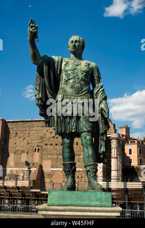 Bronze statue in front of the Roman ruins, Rome. Stock Photo