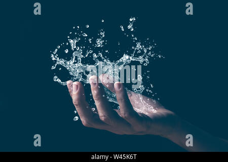 A human hand holding a splash of water.