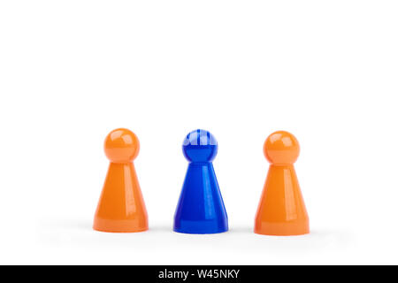Three playing plastic figures. Two orange and one different blue figurine, isolated on white background. Stock Photo