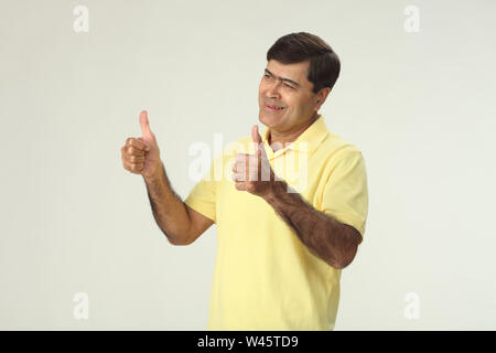 Man showing thumbs up sign Stock Photo