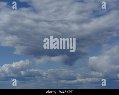 fluffy rain clouds in blue sky skyscape Stock Photo