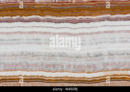 Structure of the multi colored onyx stone close up. Stock Photo