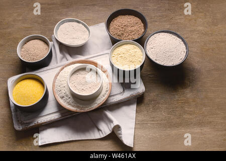 Different types of baking flour on wooden table. Stock Photo