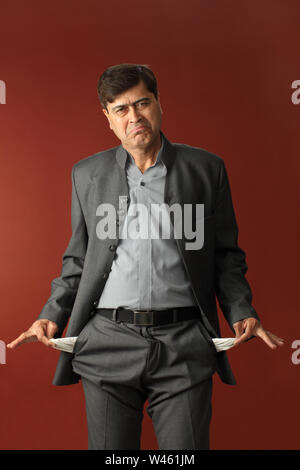 Man showing his empty pockets Stock Photo