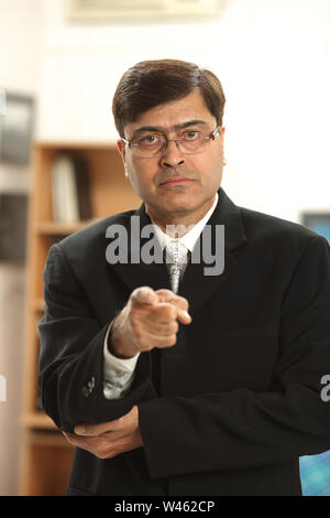 Portrait of a businessman pointing finger Stock Photo