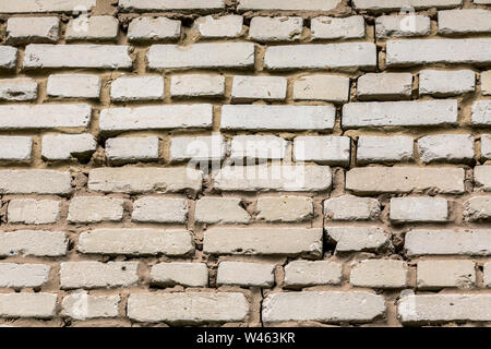 Deep cracked white silicate brick wall closeup texture and background. Horizontal shot. Stock Photo