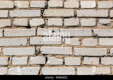 Deep cracked white silicate brick wall closeup texture and background. Horizontal shot. Stock Photo