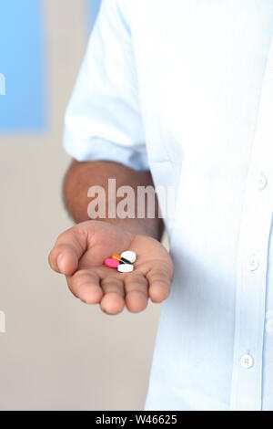 Man holding pills Stock Photo