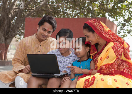 Rural family using laptop Stock Photo