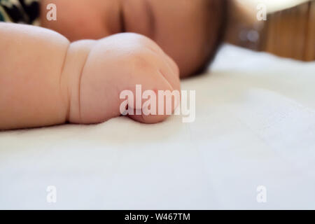 red skin bump from mosquito bite on asian baby hand while sleeping in the bedroom. family and healthcare concept. Stock Photo