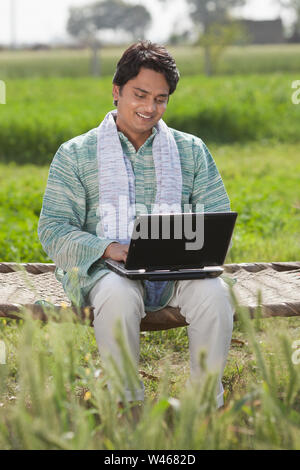 Farmer using a laptop Stock Photo
