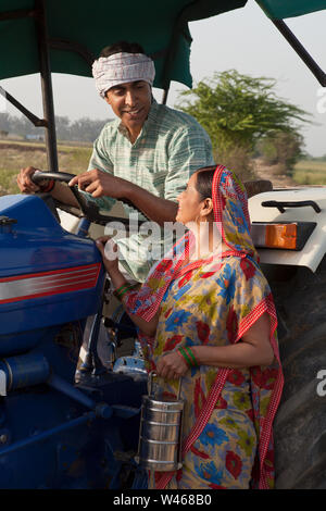 Farmer with his wife looking at each other and smiling Stock Photo