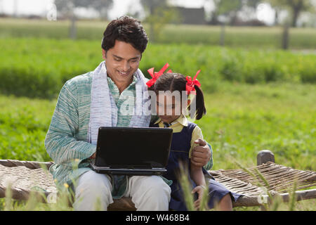 Man using laptop with his daughter Stock Photo
