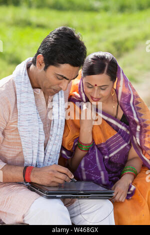 Man using digital tablet with his wife Stock Photo