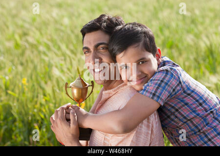 Father hugging his son and smiling Stock Photo