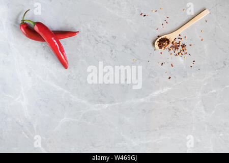 Spicy Chili paste mix with peppers on grey marble background. This condiment could be ingredient of harissa, ajika, muhammara or other middle east foo Stock Photo