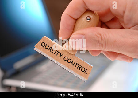 quality control printed on rubber stamp in hand