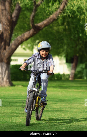 Boy riding cycle in the park Stock Photo
