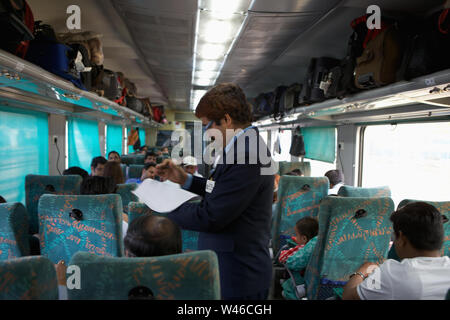 Ticket collector checking tickets in a train Stock Photo