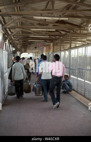 Passengers walking on overhead bridge Stock Photo