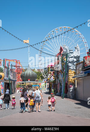 A group of adults and young children enjoying a day out at Prater amusement park, Vienna, Austria Stock Photo