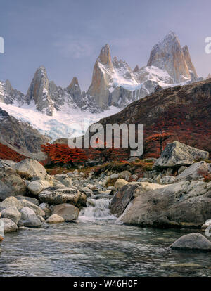 Amazing color of FitzRoy mountain peak and sky before sunset. Small waterfall near mountain range. Los Glaciares National Park. Andes. Argentina.
