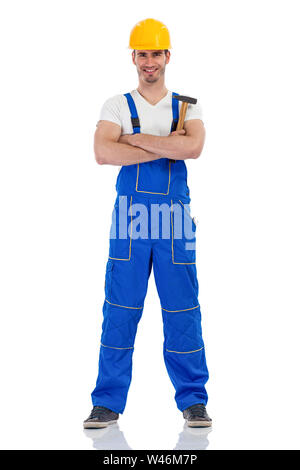 Cheerful male construction worker standing over white Stock Photo